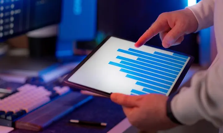 Business analyst reviewing SAP performance charts on a tablet